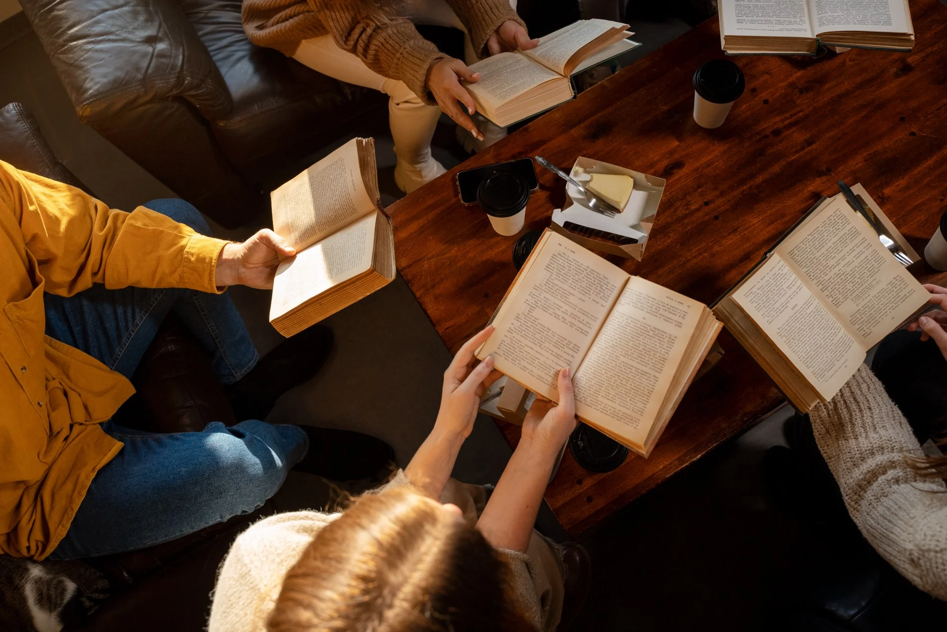 high-angle-people-reading-together